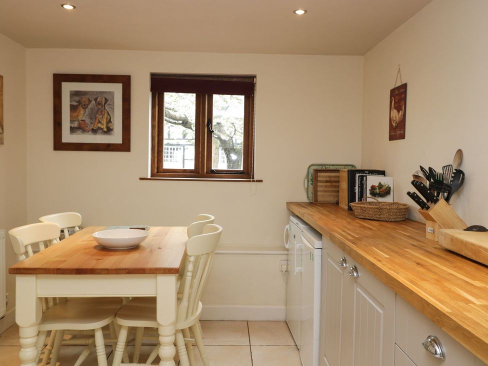 A kitchen with a table and chairs at The Old Barn in Hereford