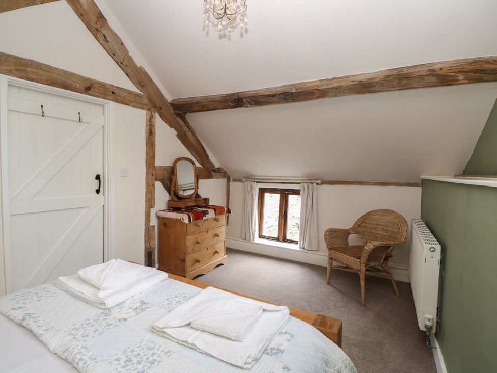 A bedroom with a bed and dressing table at The Old Barn in Hereford