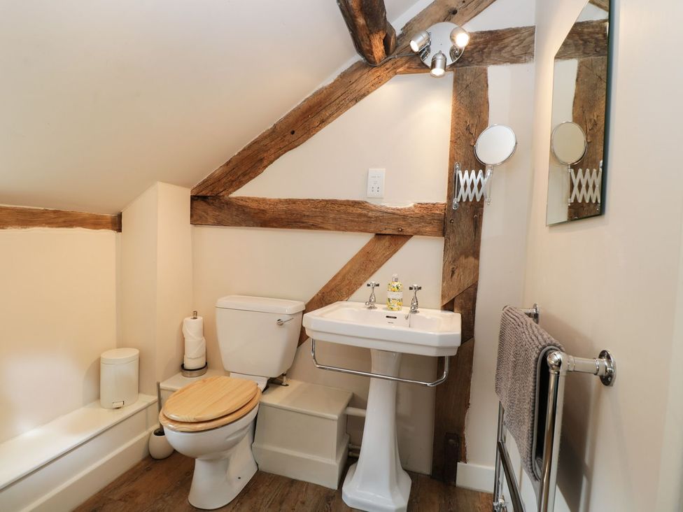 A bathroom with a toilet and sink at The Old Barn in Hereford