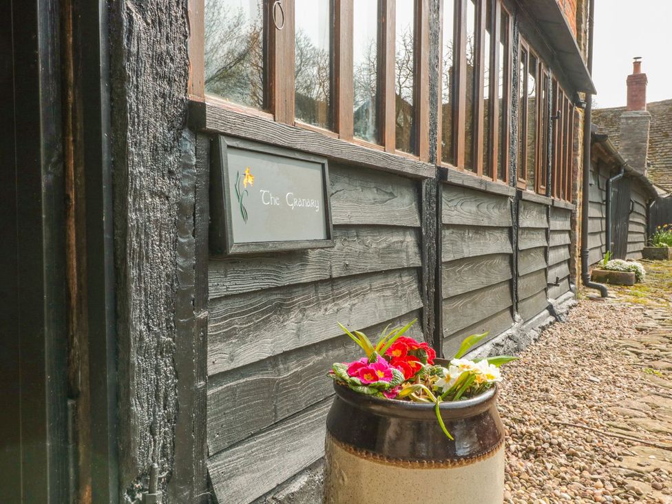 An outdoor area with a sign and flower pot at The Granary in Hereford