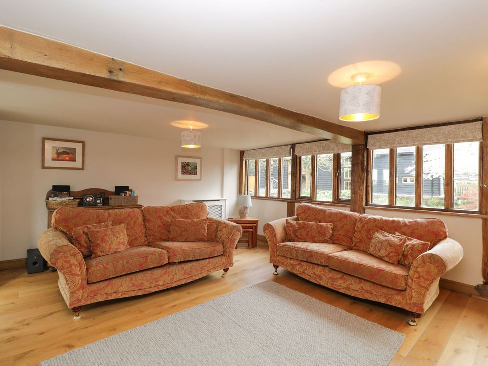 A living room with two sofas and hardwood flooring at The Granary in Hereford