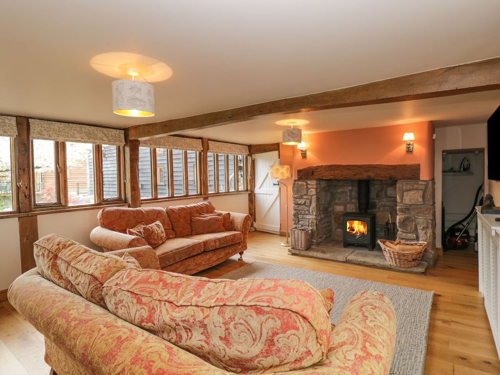 A living room with a fireplace and sofas at The Granary in Hereford