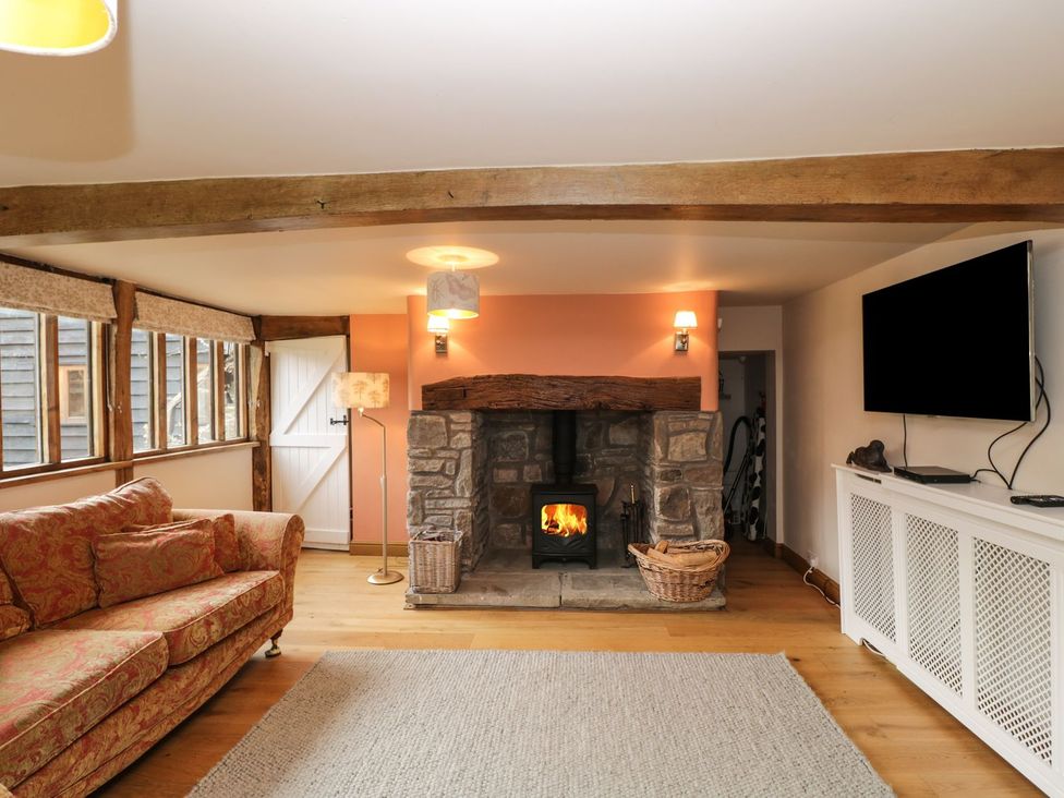 A living room with a fireplace and a sofa at The Granary in Hereford