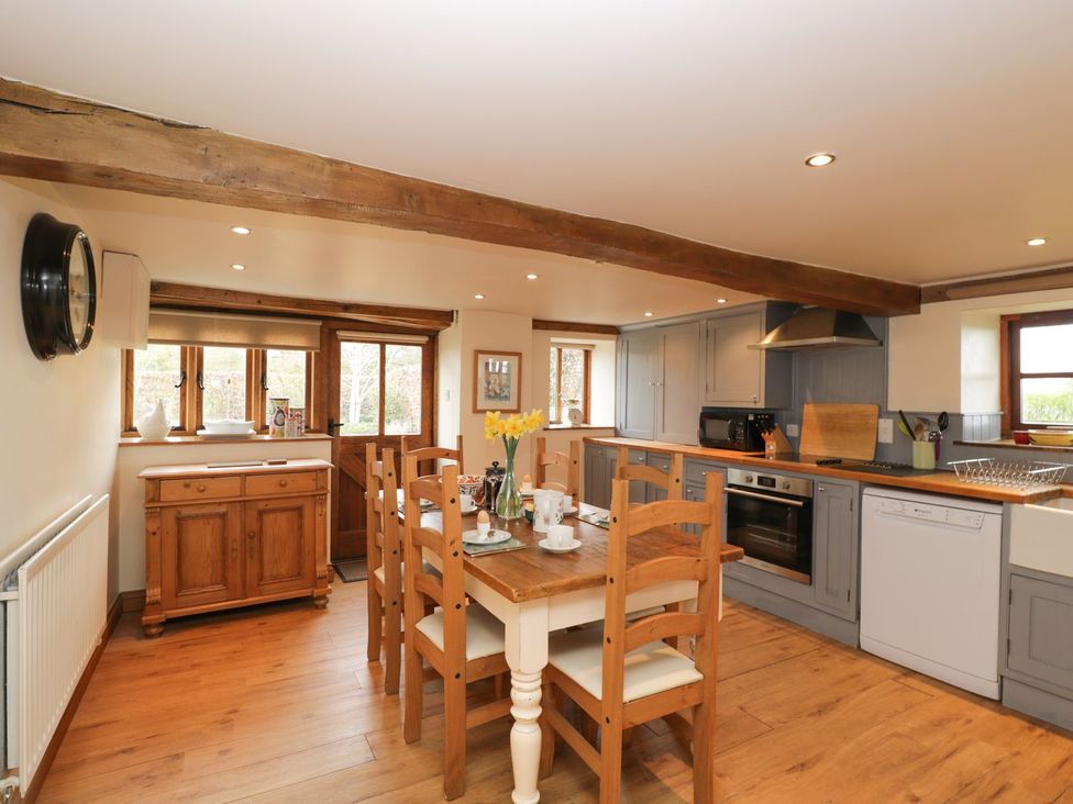 A kitchen with a dining table and chairs at The Granary in Hereford