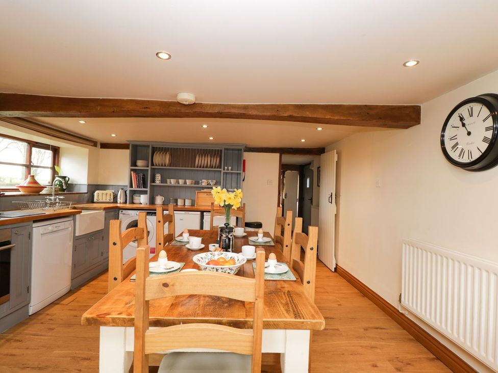 A kitchen with a dining table and chairs at The Granary in Hereford