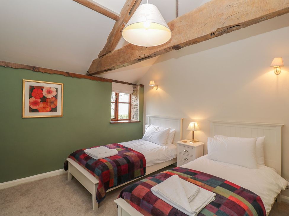 A bedroom with two beds and a window at The Granary in Hereford