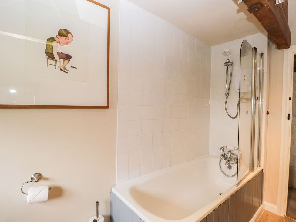 A bathroom with a bathtub and shower at The Granary in Hereford