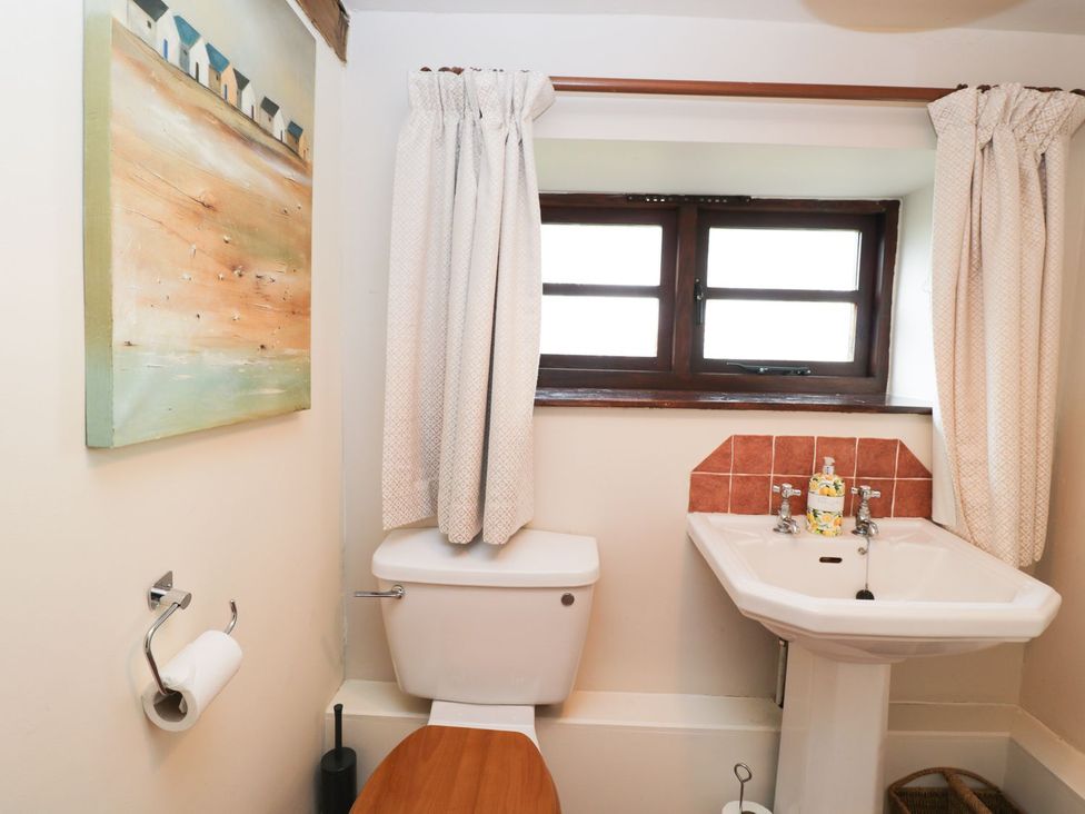 A bathroom with a toilet and sink at The Granary in Hereford
