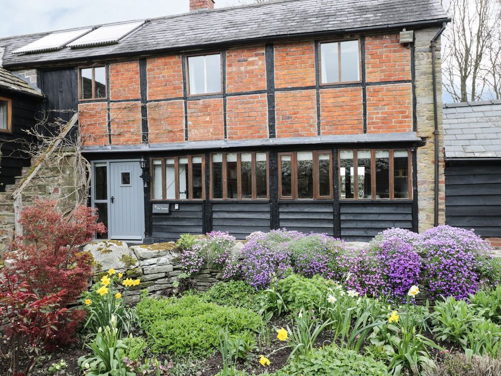 A house exterior with garden and flowers at The Granary Hereford