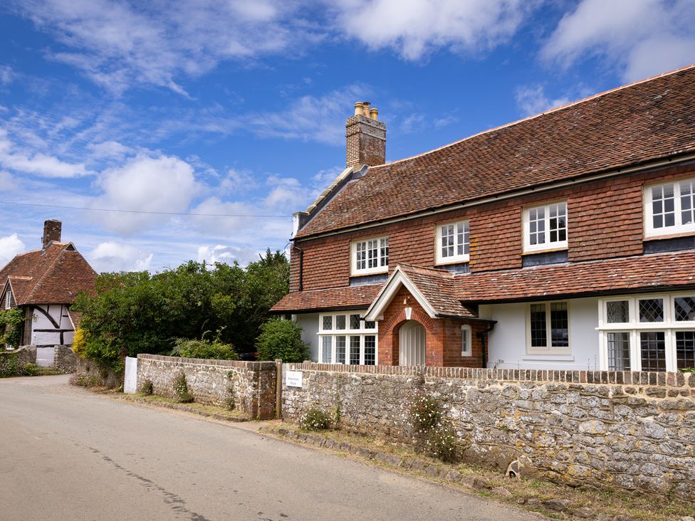 A house with a front door and windows at Ambersham House in Midhurst