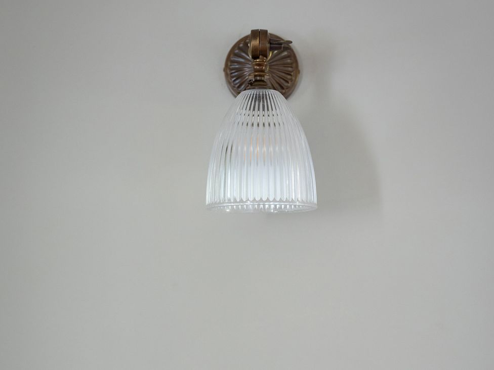 A light fixture with glass shade at Ambersham House in Midhurst