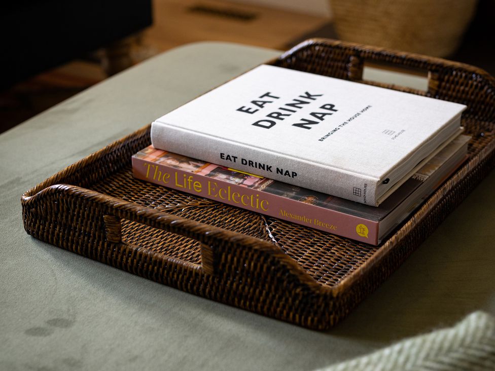 A tray with books in a living room at Ambersham House in Midhurst