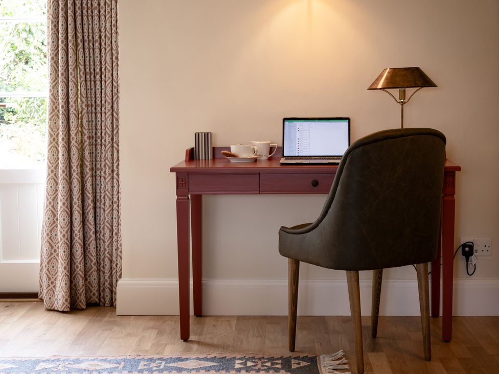 An office with a desk and laptop at Ambersham House in Midhurst