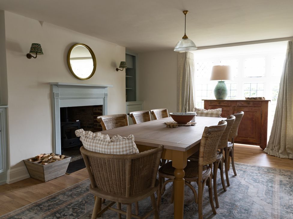 A dining room with a table and chairs at Ambersham House in Midhurst