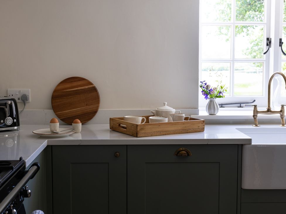 A kitchen with a sink and kitchenware at Ambersham House in Midhurst
