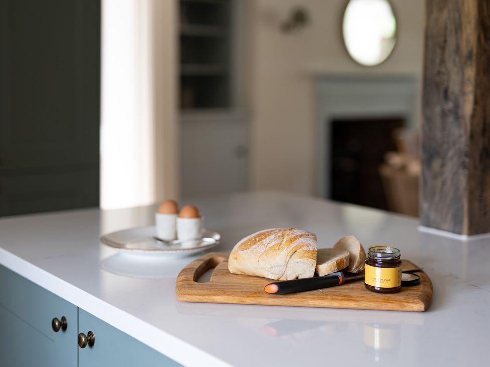 A kitchen with bread and eggs on a cutting board at Ambersham House in Midhurst