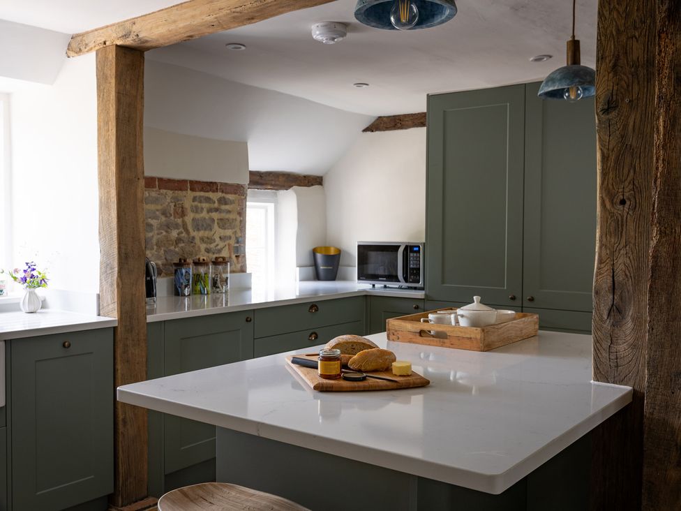 A kitchen with countertop and cabinets at Ambersham House in Midhurst