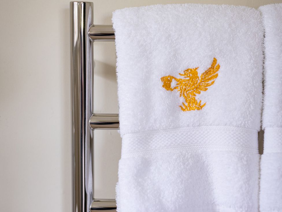 A towel rack with towels in a bathroom at Ambersham House in Midhurst