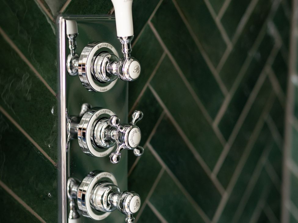 A close-up of shower controls in a bathroom at Ambersham House in Midhurst