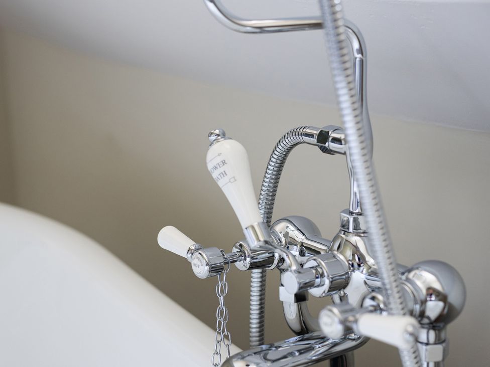 A faucet and controls for a shower in a bathroom at Ambersham House in Midhurst