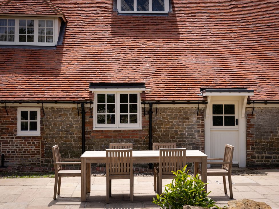 An outdoor dining table and chairs at Ambersham House in Midhurst
