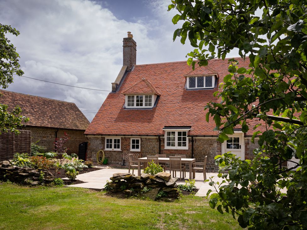 A house with a patio and garden at Ambersham House in Midhurst