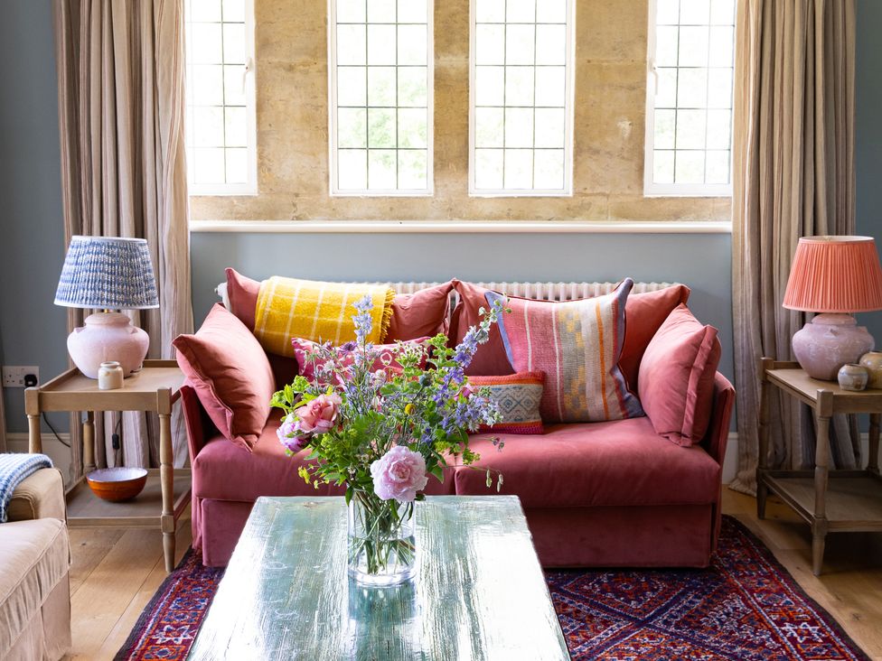 A living room with a sofa and flower vase at Costers Lodge in Midhurst