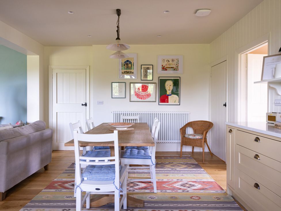 A dining room with a table and chairs at Costers Lodge in Midhurst