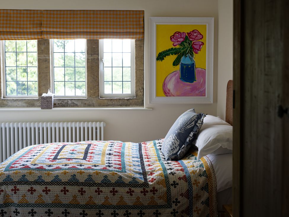 A bedroom with a bed and quilt at Costers Lodge in Midhurst