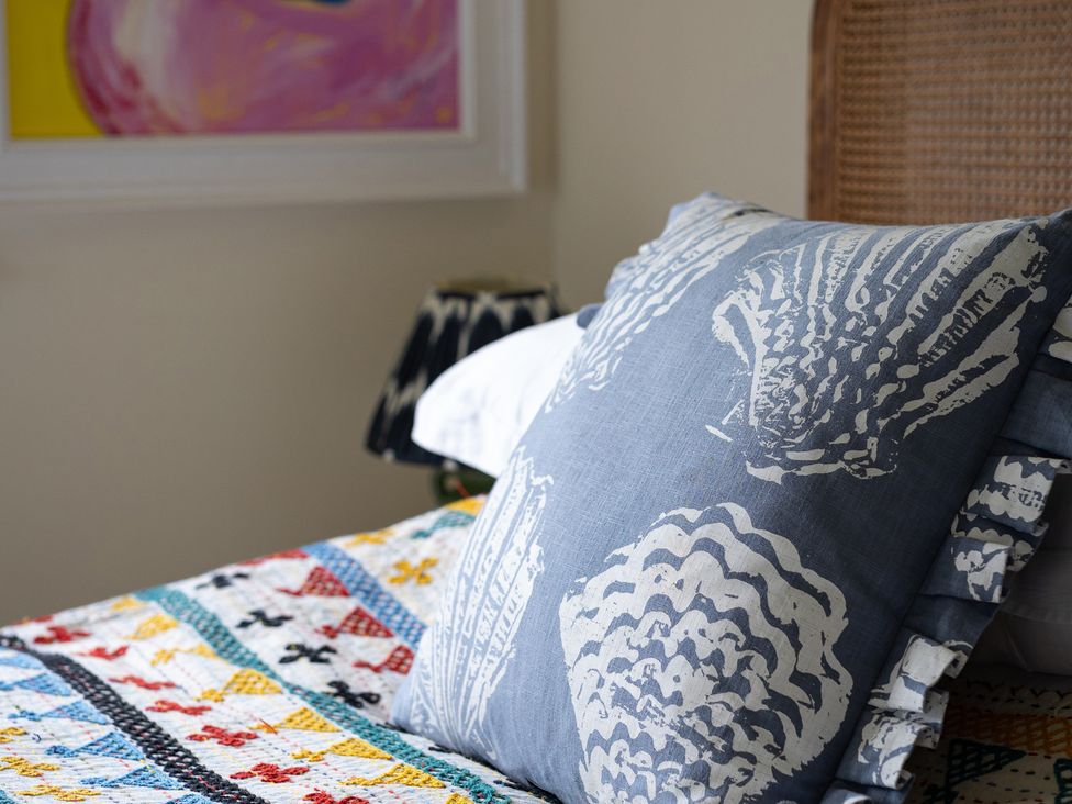 A pillow and quilt on a bed at Costers Lodge in Midhurst