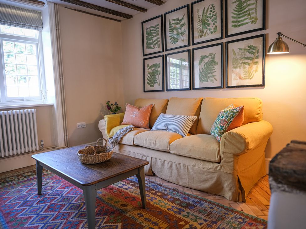 A living room with a sofa and coffee table at Challens Yarde in Midhurst