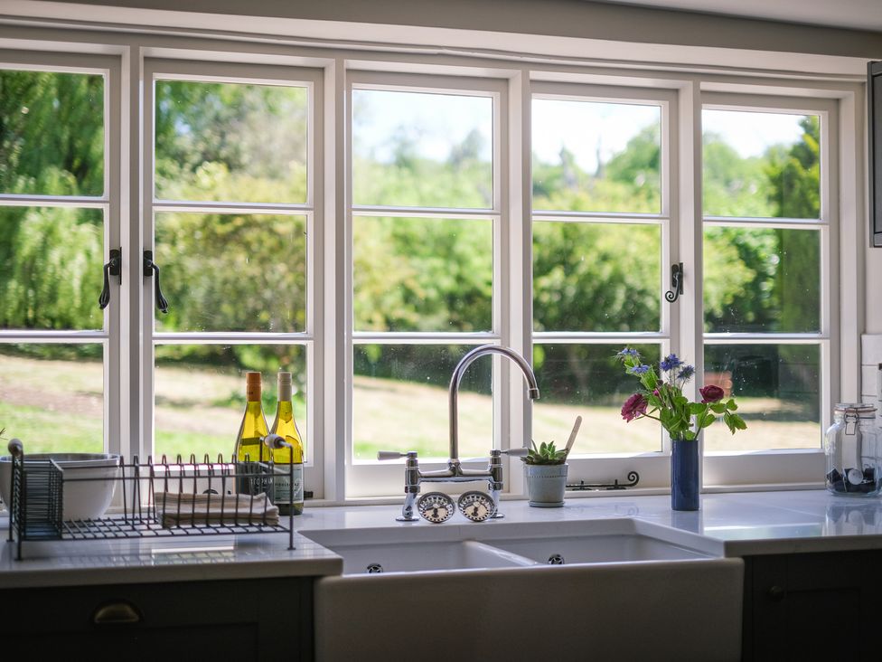 A kitchen sink with a view of the garden at Challens Yarde in Midhurst