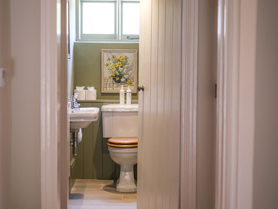 A bathroom with a toilet and sink at Challens Yarde in Midhurst
