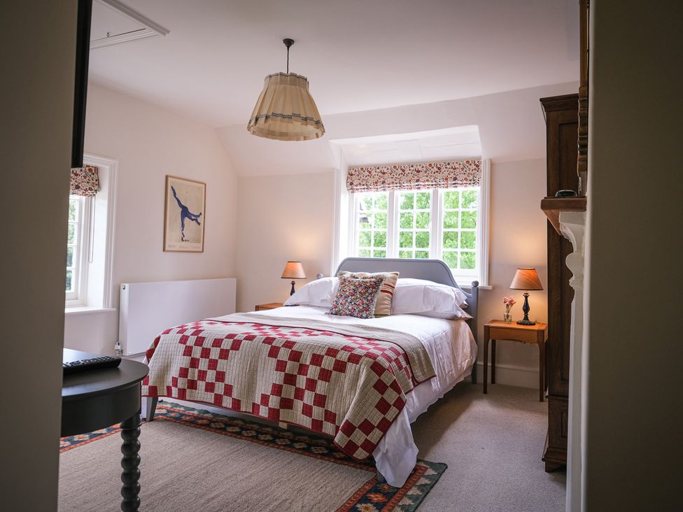 A bedroom with a bed and lamp at Challens Yarde in Midhurst