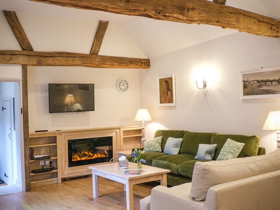 A living room with a sofa and coffee table at Broomhill cottage in Petworth