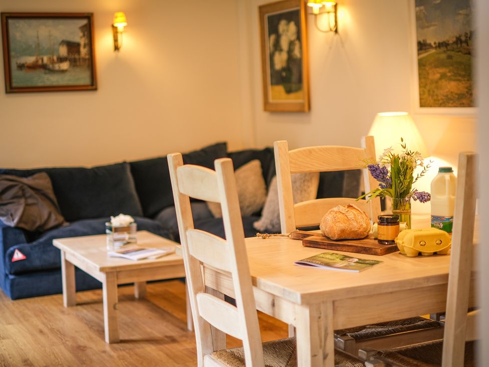 A dining room with a table and chairs at Heathe End in Lodsworth near Eastbourne