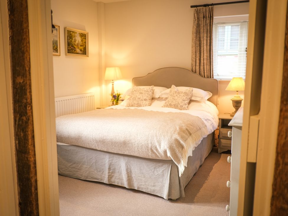 A bedroom with a bed and lamp at Heathe End in Lodsworth near Eastbourne
