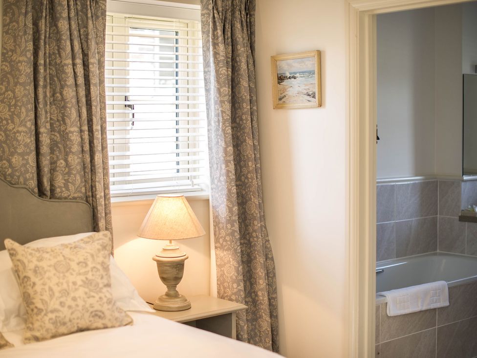 A bedroom with a bed and lamp at Heathe End in Lodsworth near Eastbourne