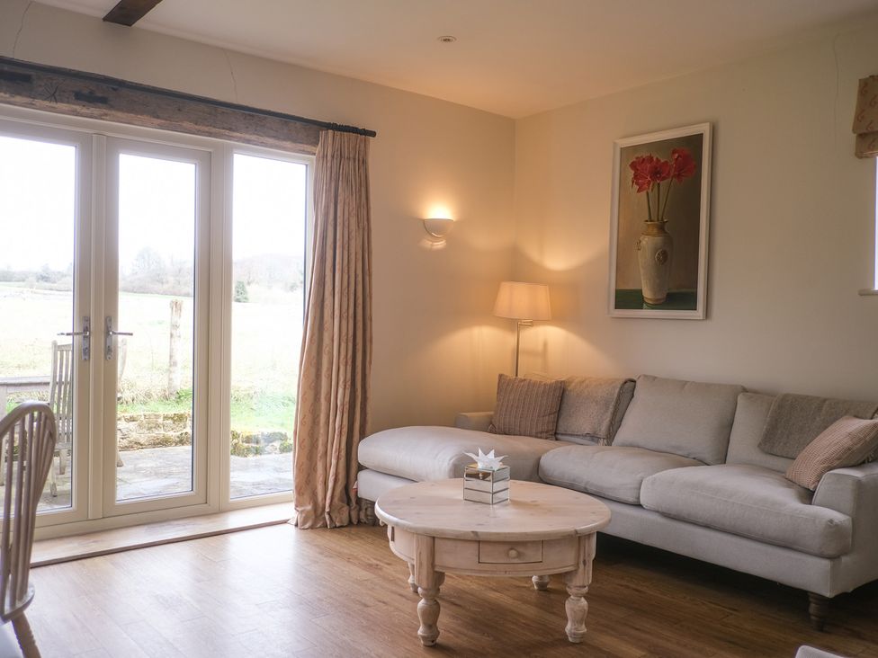 A living room with a sofa and coffee table at High Field in Petworth