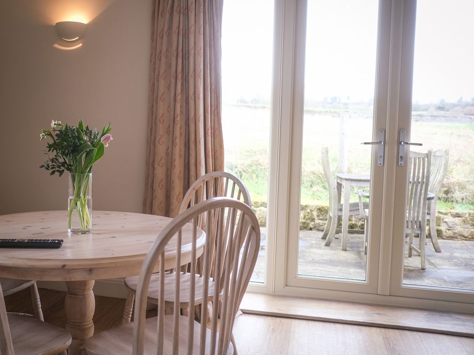 A dining room with a wooden table and chairs at High Field in Petworth