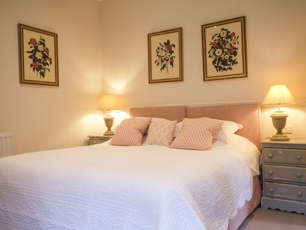 A bedroom with a bed and lighting at High Field in Petworth
