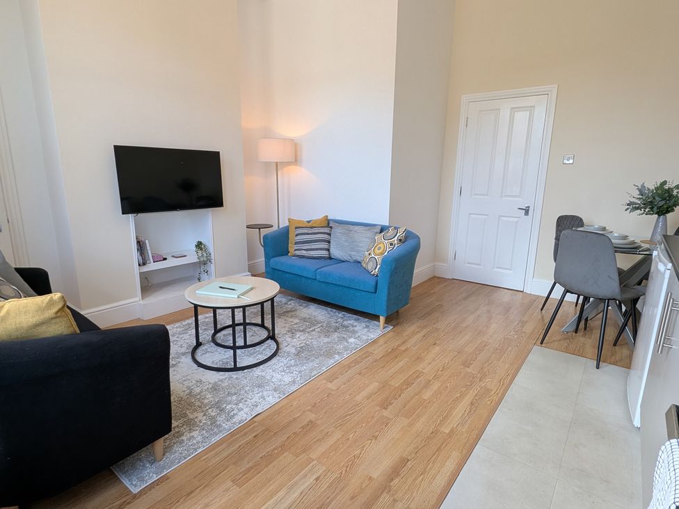 A living room with a sofa and television at Flat 3 in Poole