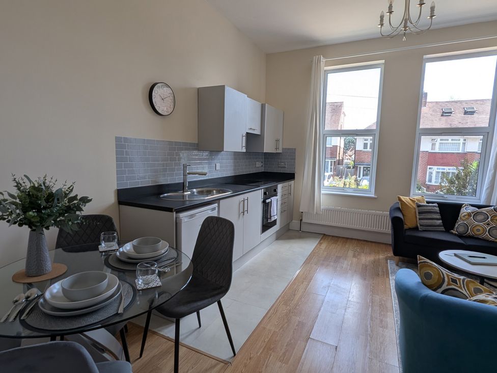 A kitchen with table and chairs at Flat 3 in Poole