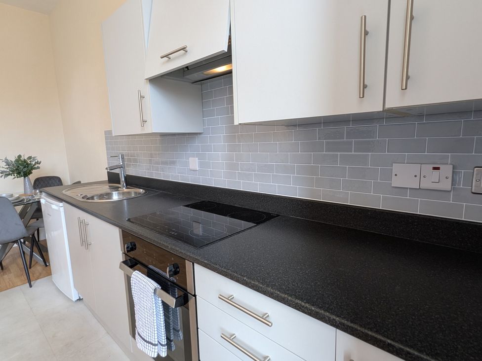 A kitchen with a sink and cooker at Flat 3 in Poole