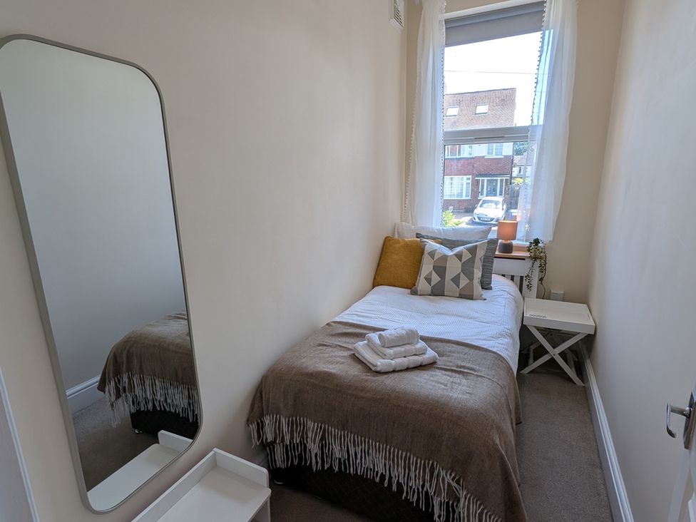 A bedroom with a bed and side table at Flat 3 in Poole