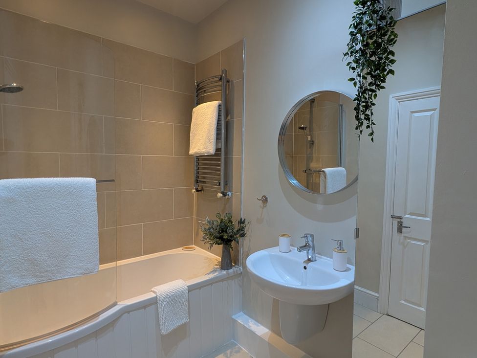 A bathroom with a sink and bathtub at Flat 3 in Poole
