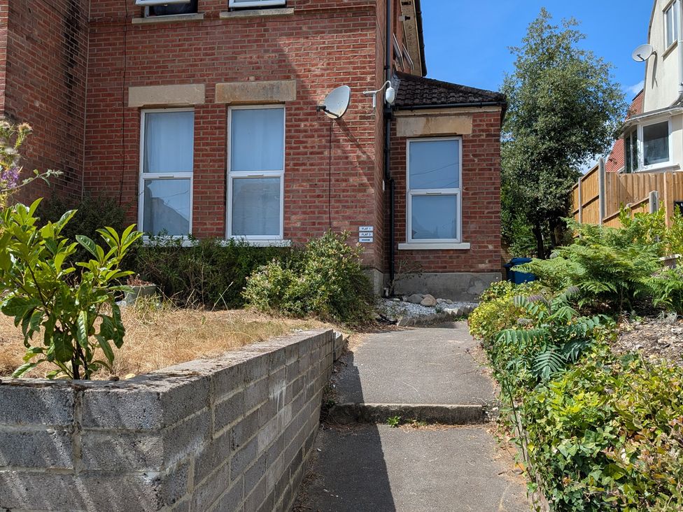 A house with windows and a pathway at Flat 3 in Poole