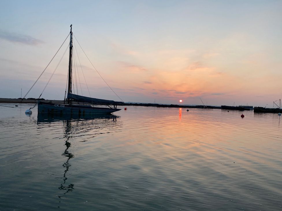 A sailboat on water at sunset at Oakwood Annexe, Colchester