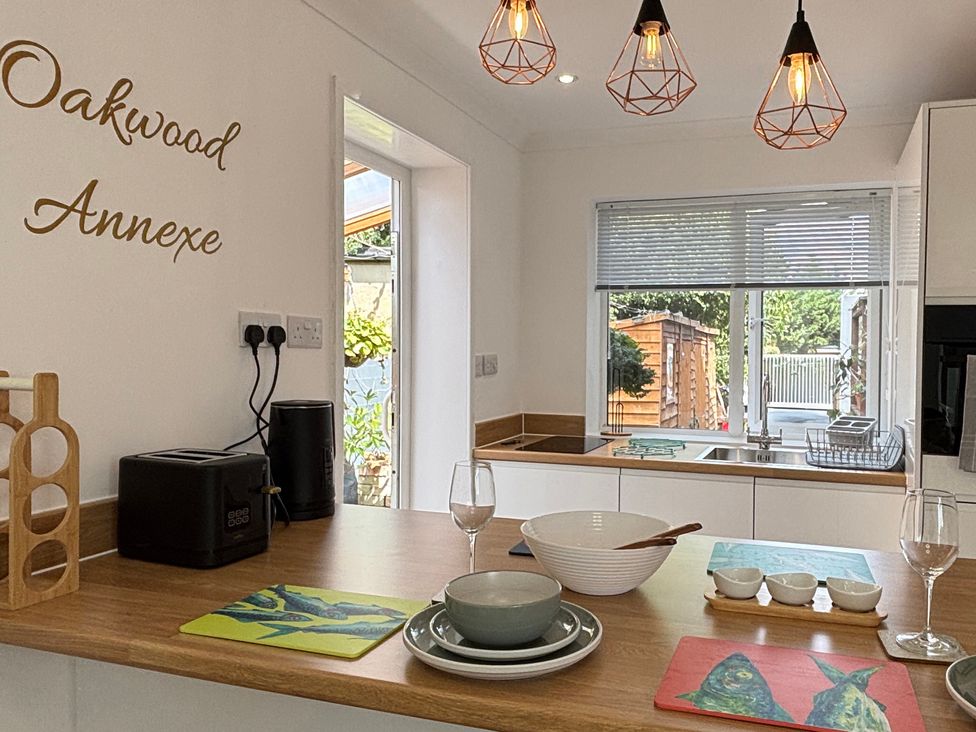 A kitchen with countertop and dining setup at Oakwood Annexe in Colchester