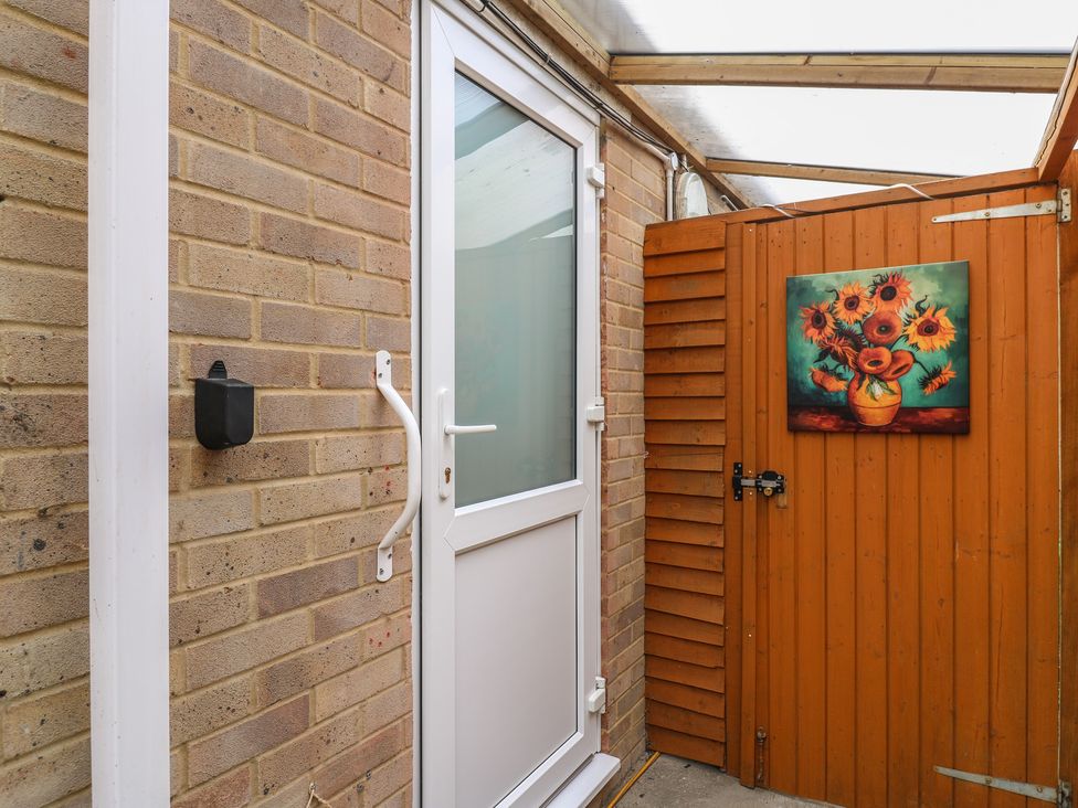 An outdoor area with a door and a painting at Oakwood Annexe in Colchester